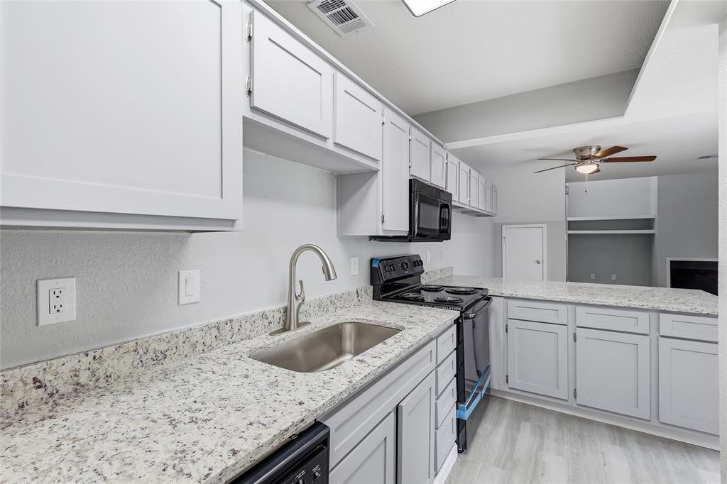 620 West Union Bower Road Irving, TX 75061 - Photo 8 of 22 Kitchen featuring black appliances, ceiling fan, light stone countertops, light wood-type flooring, and a peninsula