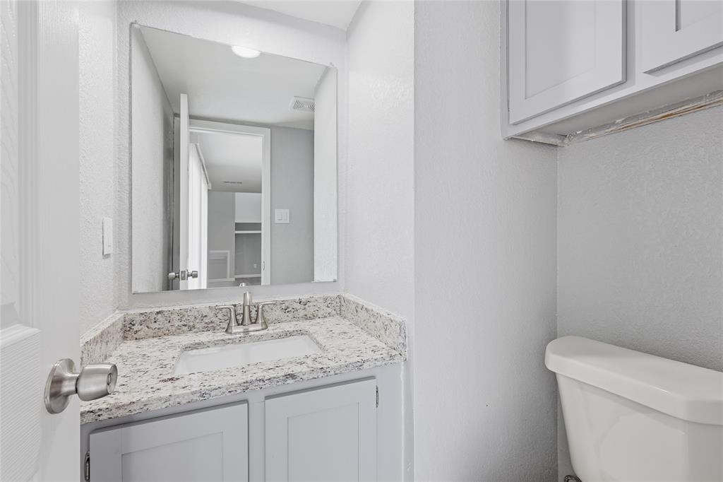 620 West Union Bower Road Irving, TX 75061 - Photo 9 of 22 Powder bathroom featuring a textured wall and vanity