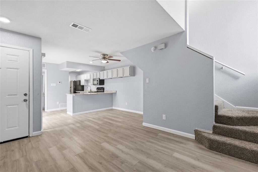 620 West Union Bower Road Irving, TX 75061 - Photo 10 of 22 Unfurnished living room with ceiling fan and light wood-style floors