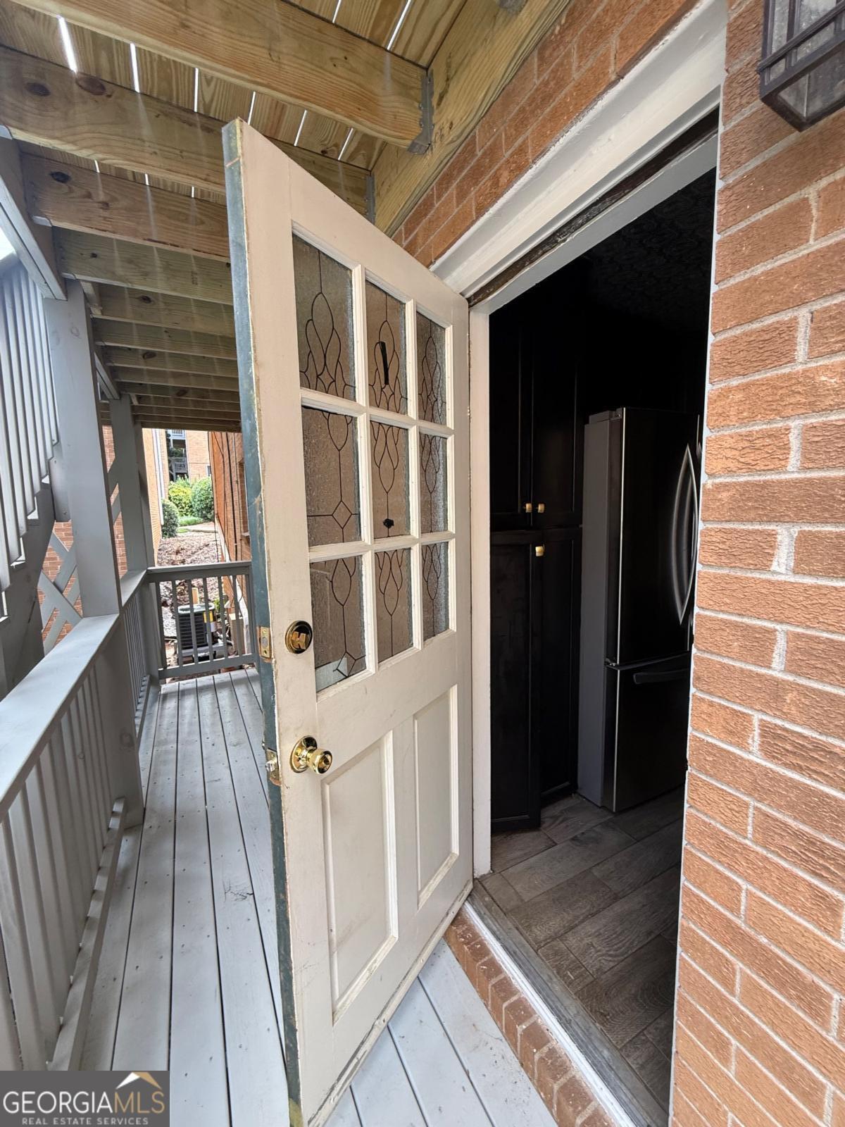 3510 Roswell Road, Unit H1 Atlanta, GA 30326 - Photo 28 of 43 a view of a balcony with wooden floor and stairs