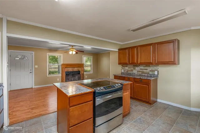 a kitchen with granite countertop cabinets stainless steel appliances and a counter space