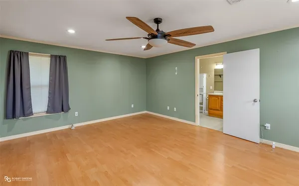 an empty room with closet and fan