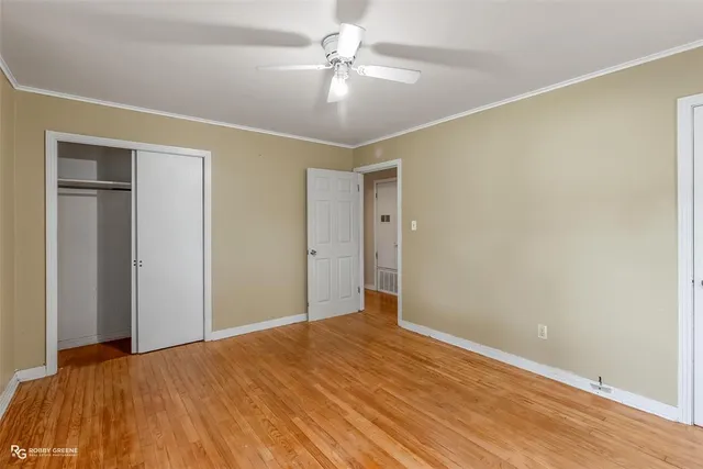a view of empty room with wooden floor