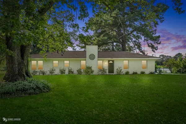 a front view of a house with a yard and a garage