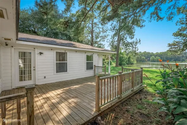 a view of a house with backyard and wooden floor