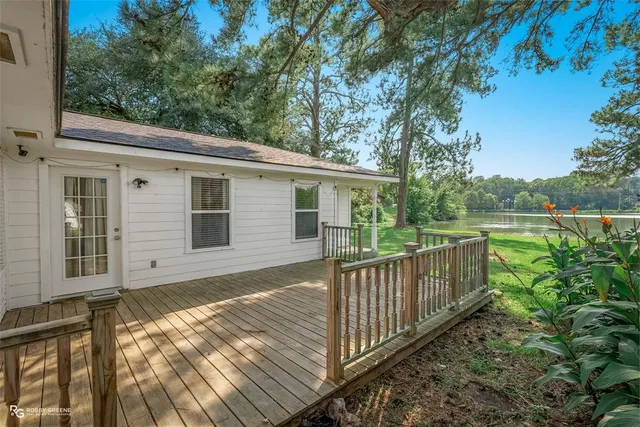 a view of a house with backyard and wooden floor