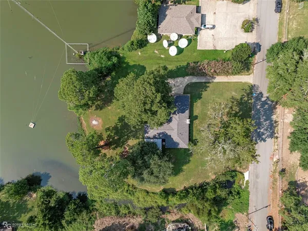 an aerial view of a house with a yard
