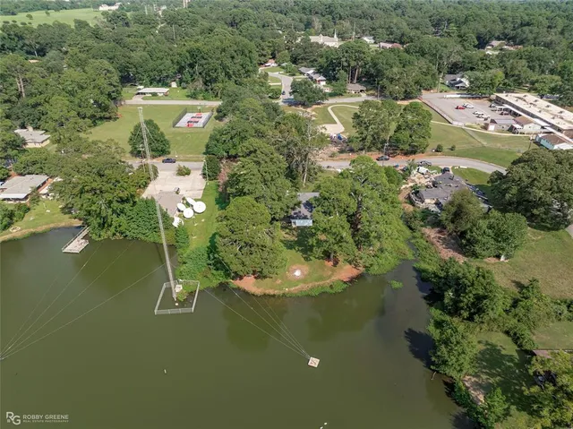 an aerial view of residential house with outdoor space and lake view