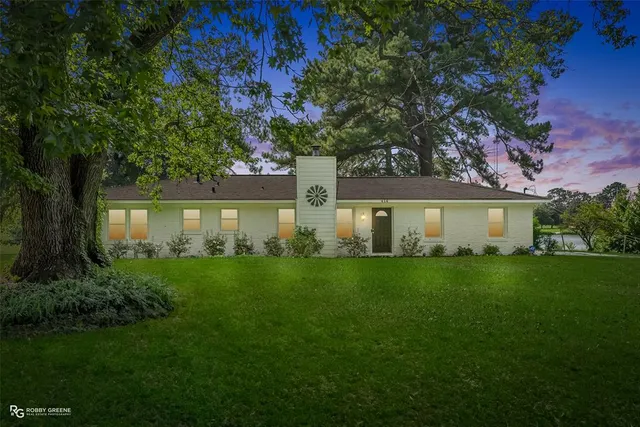 a front view of a house with a yard and a garage