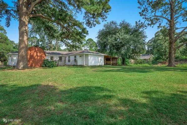 a view of house with backyard