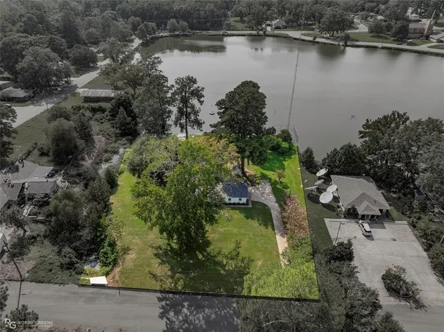 an aerial view of residential house with outdoor space and lake view