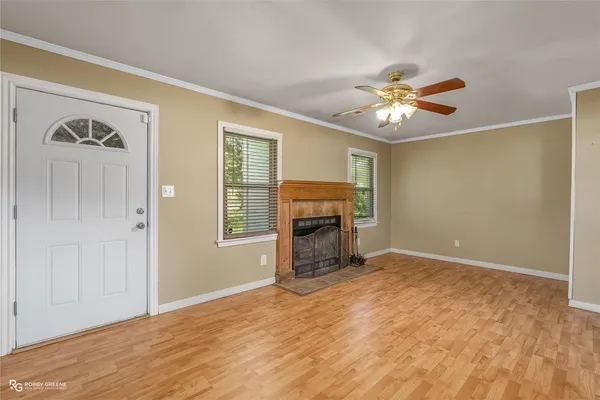 a view of empty room with a fireplace and fan
