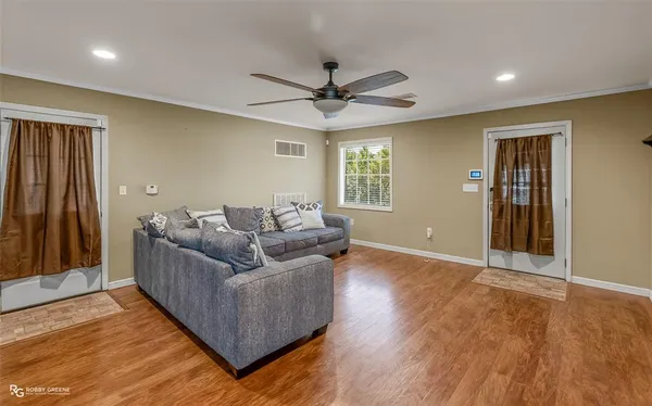 a living room with furniture and a ceiling fan