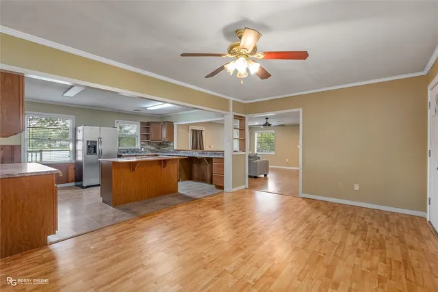 a view of kitchen with granite countertop cabinets and refrigerator