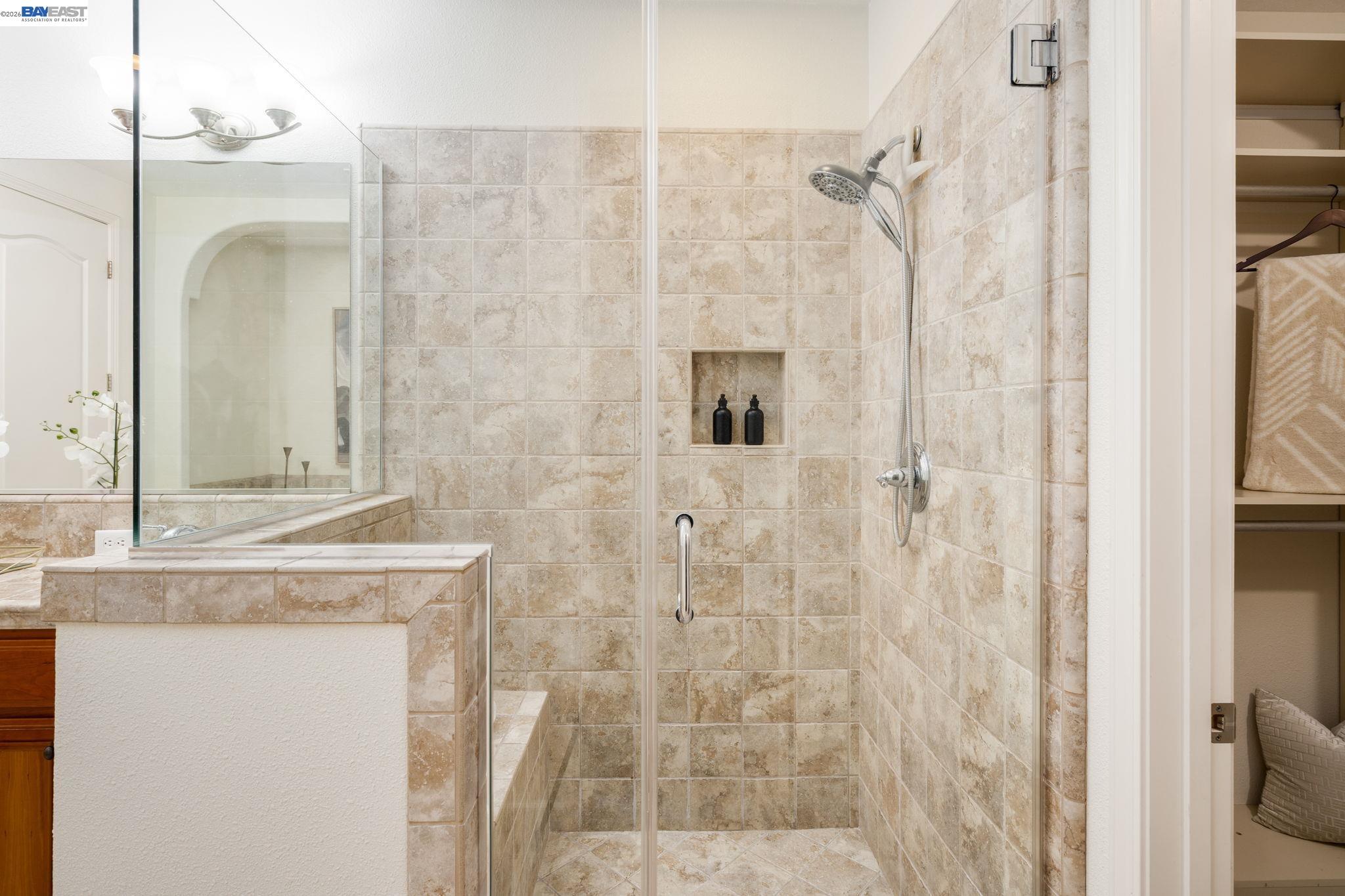 4653 Rimini Court Dublin, CA 94568 - Photo 30 of 44 a bathroom with a granite countertop shower mirror and a sink
