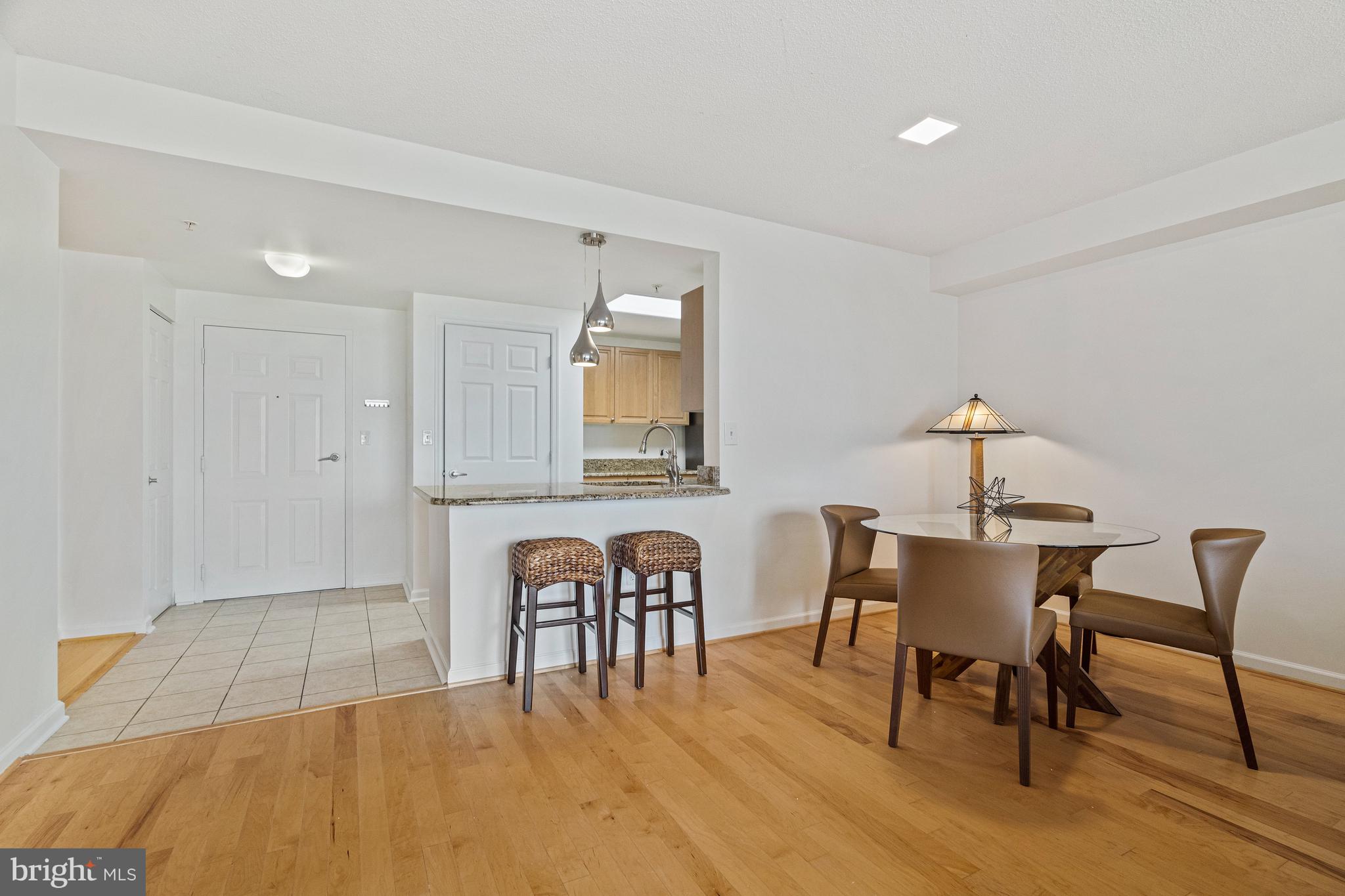 2726 Gallows Road, Unit 712 Vienna, VA 22180 - Photo 14 of 55 a dining room with furniture and wooden floor