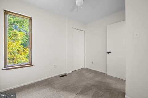 a view of room with window and closet area