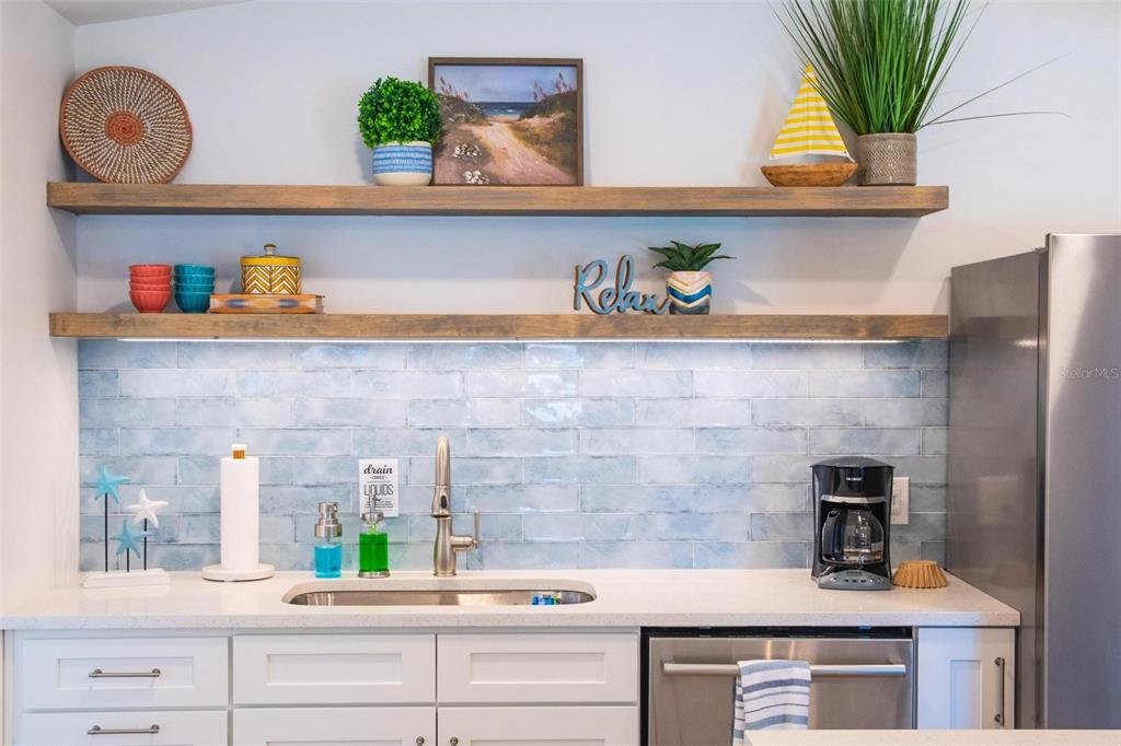 110 Terrapin Road St. Augustine, FL 32086 - Photo 11 of 33 a kitchen with a potted plant on the counter and cabinets