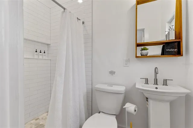 a bathroom with a sink a mirror and a window