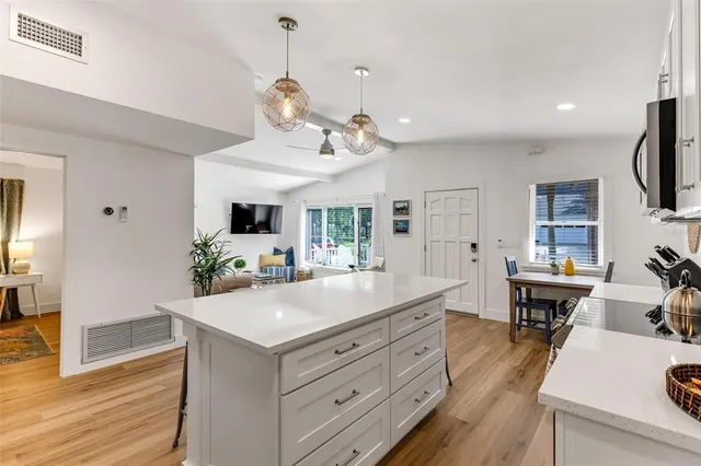 a living room with kitchen island furniture and a wooden floor