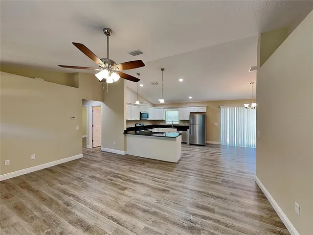 a view of kitchen with sink and wooden floor
