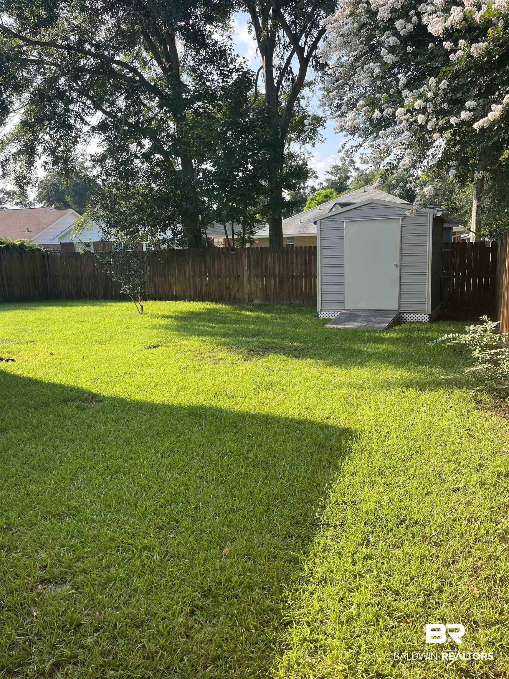 309 Cluster Street Foley, AL 36535 - Photo 35 of 38 Expansive green lawn featuring a metal storage shed with a ramp entrance