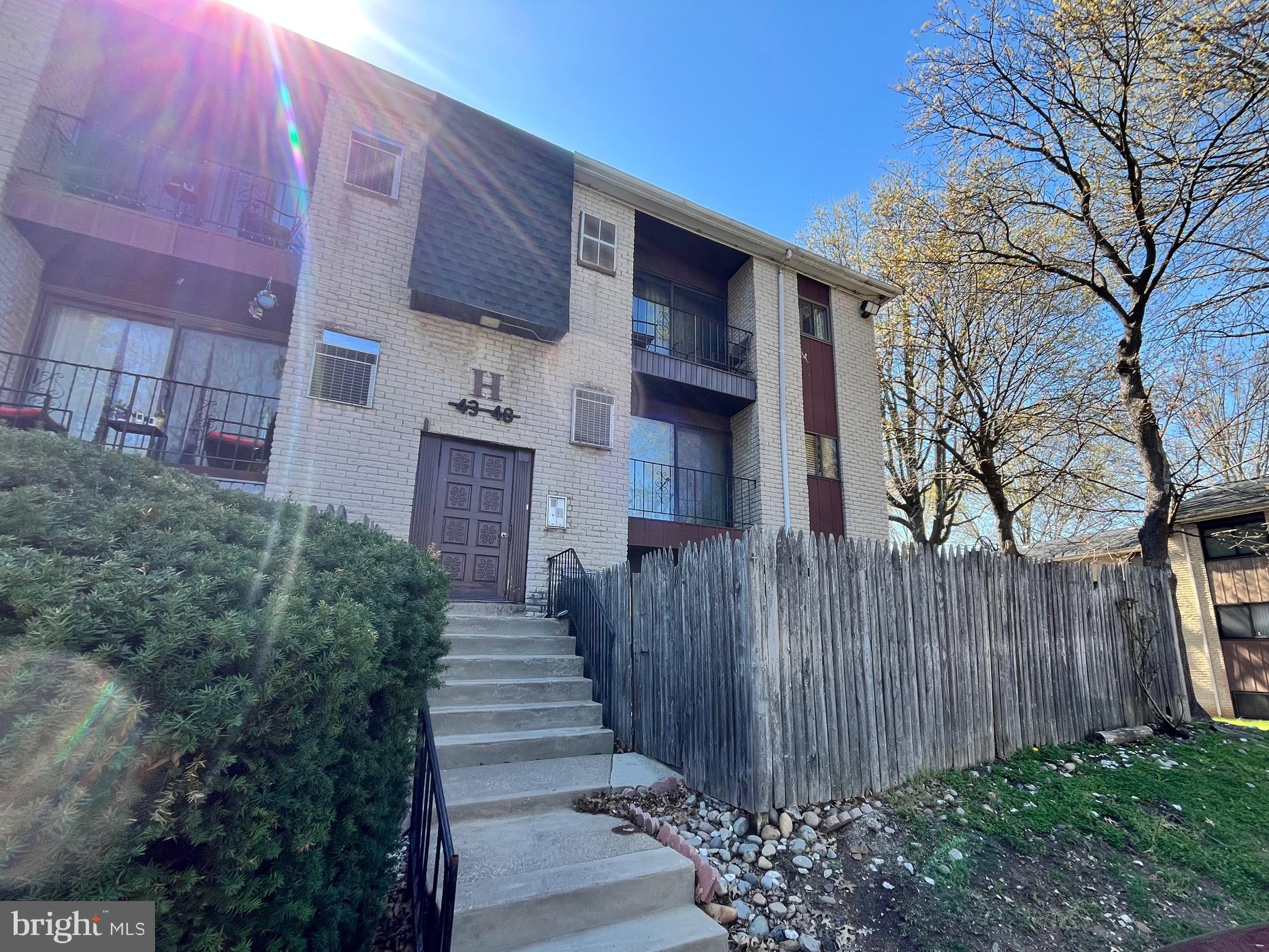 8030 Ditman Street, Unit 44H Philadelphia, PA 19136 - Photo 1 of 25 a view of a house with wooden fence next to a yard
