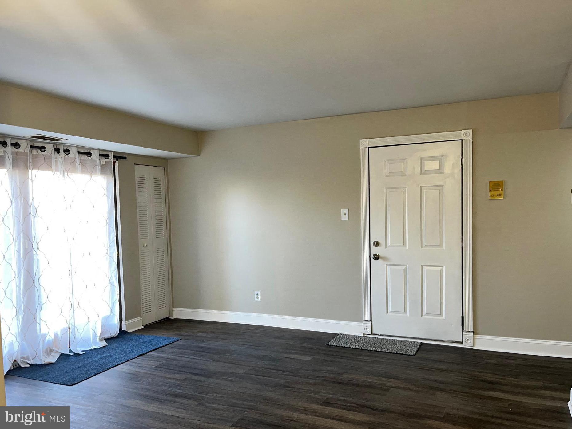 8030 Ditman Street, Unit 44H Philadelphia, PA 19136 - Photo 12 of 25 a view of an empty room with wooden floor and a window