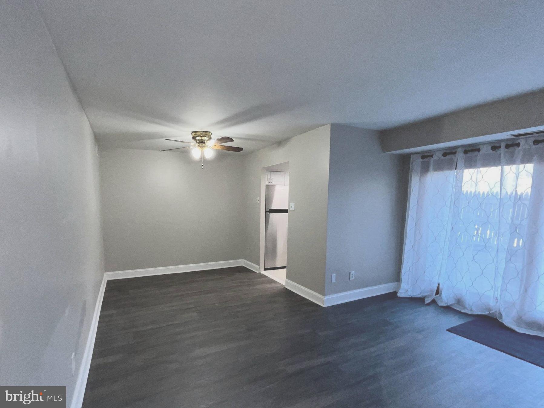 8030 Ditman Street, Unit 44H Philadelphia, PA 19136 - Photo 14 of 25 an empty room with wooden floor fan and windows