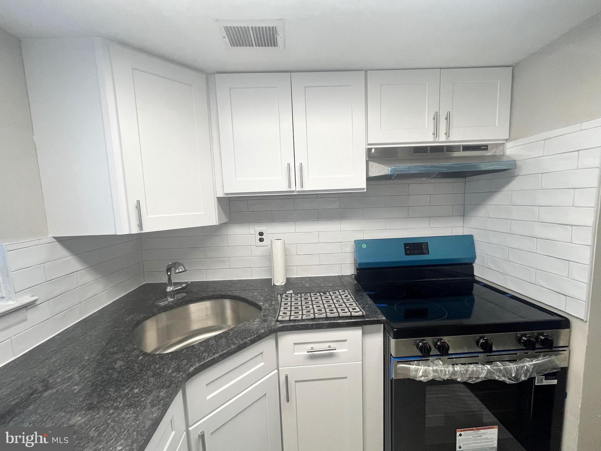 8030 Ditman Street, Unit 44H Philadelphia, PA 19136 - Photo 23 of 25 a kitchen with a sink and cabinets
