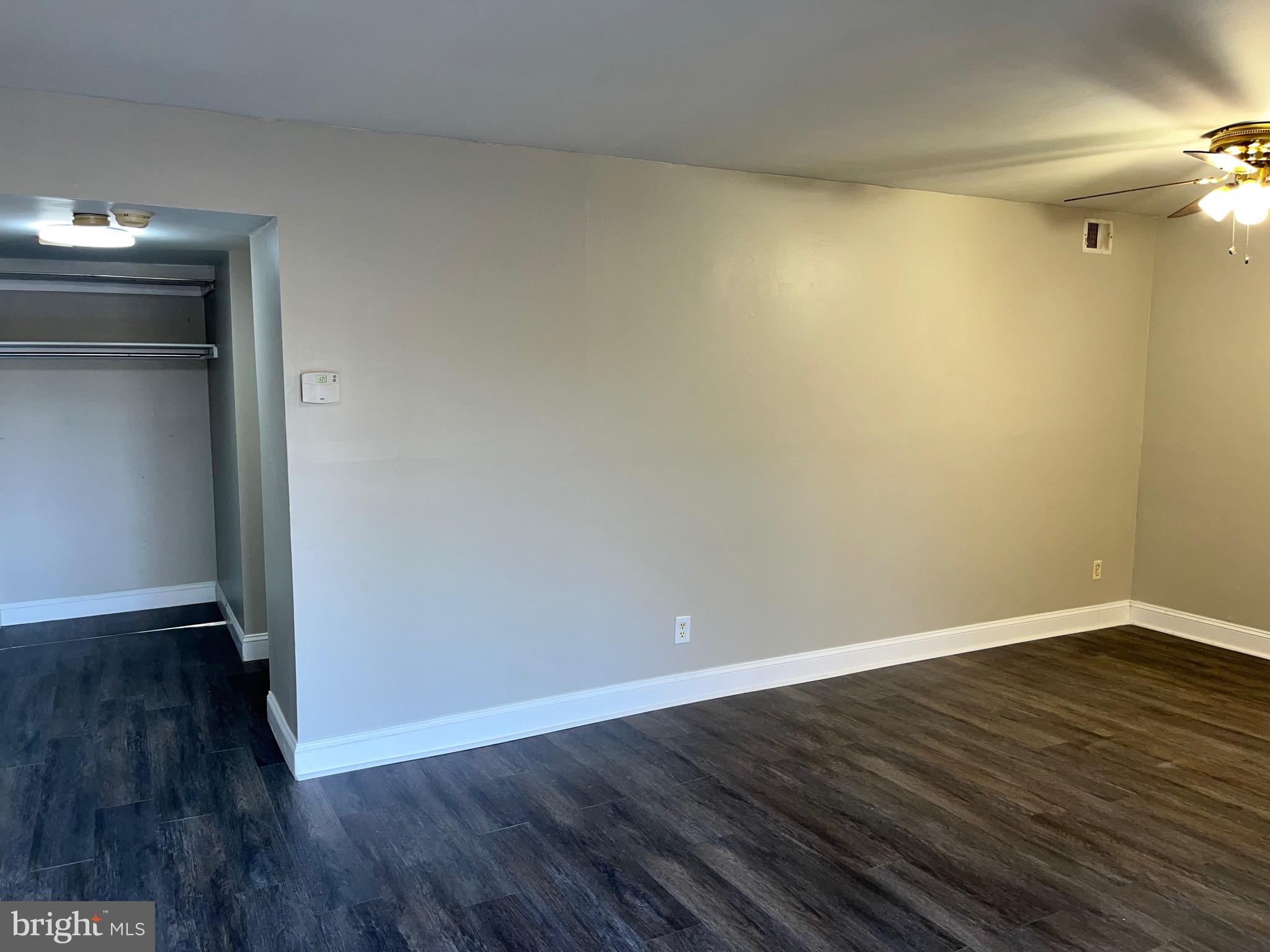 8030 Ditman Street, Unit 44H Philadelphia, PA 19136 - Photo 7 of 25 a view of an empty room with wooden floor and a window