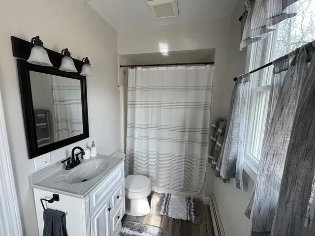 a bathroom with a sink toilet and shower