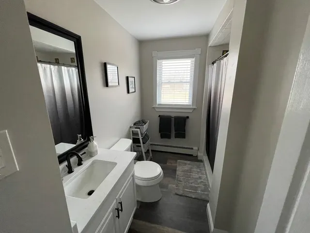 a bathroom with a sink a toilet and a mirror