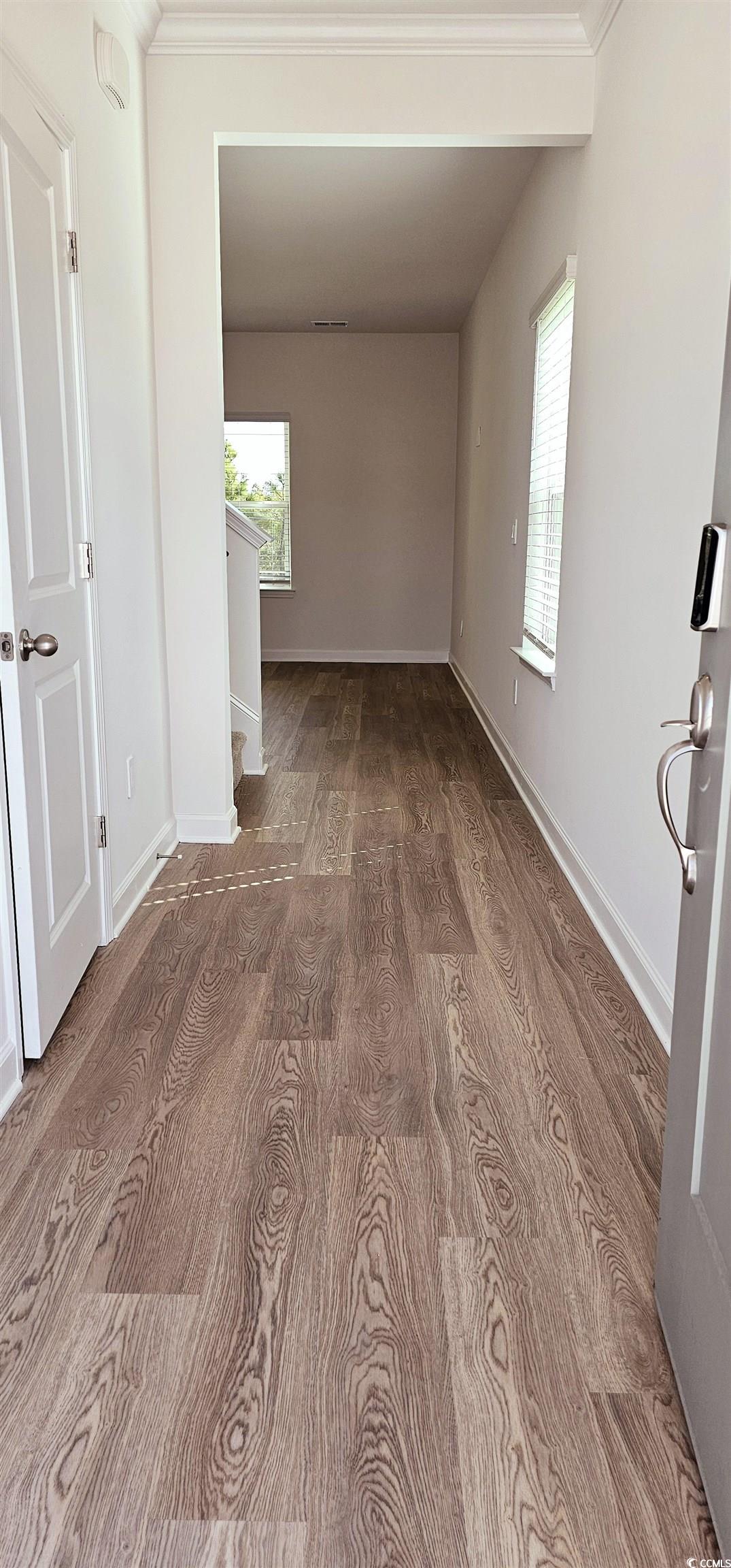 8233 Vibrant Loop Columbia, SC 29209 - Photo 4 of 40 Empty room featuring wood finished floors, healthy amount of natural light, and crown molding