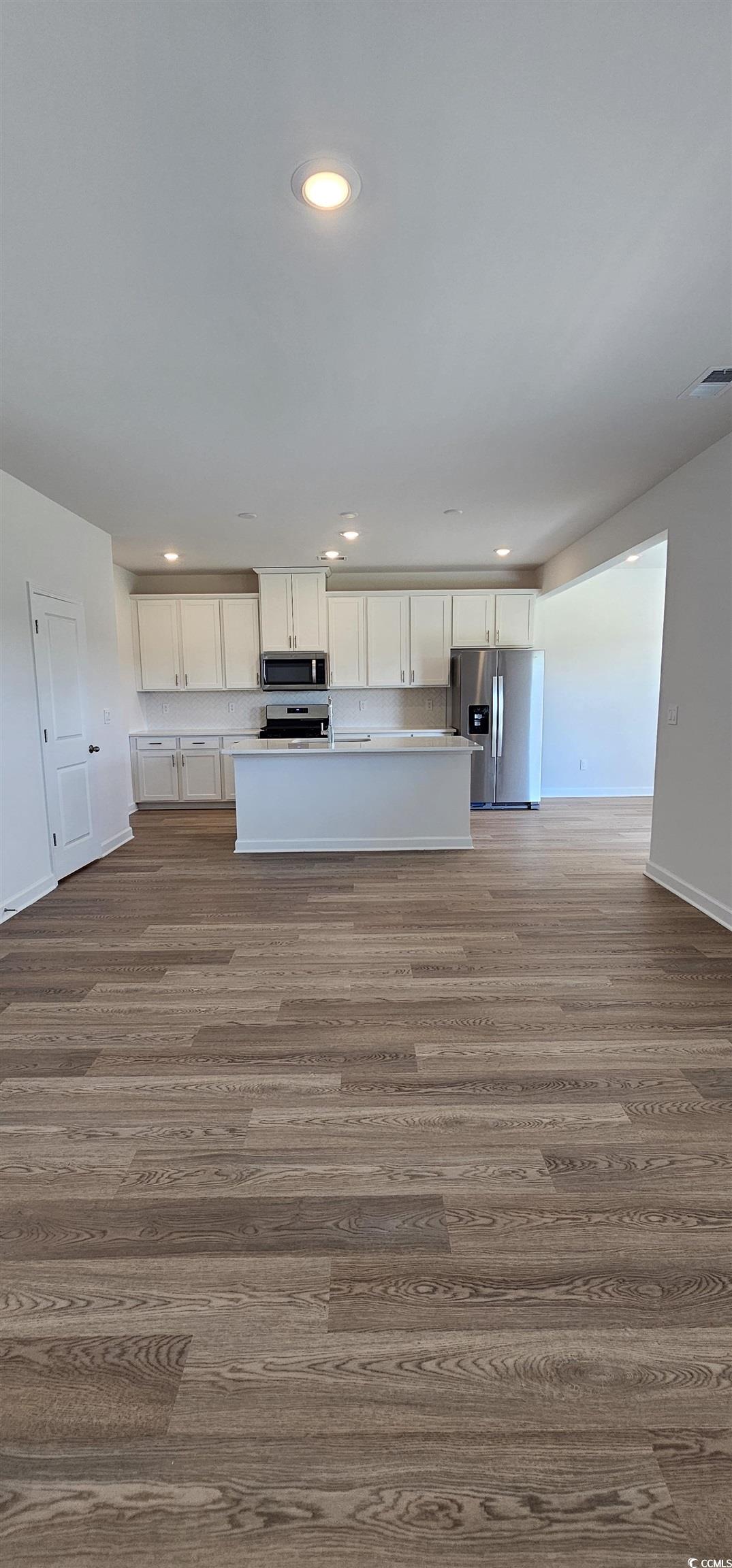 8233 Vibrant Loop Columbia, SC 29209 - Photo 7 of 40 Kitchen featuring white cabinets, recessed lighting, light countertops, stainless steel appliances, and an island with sink