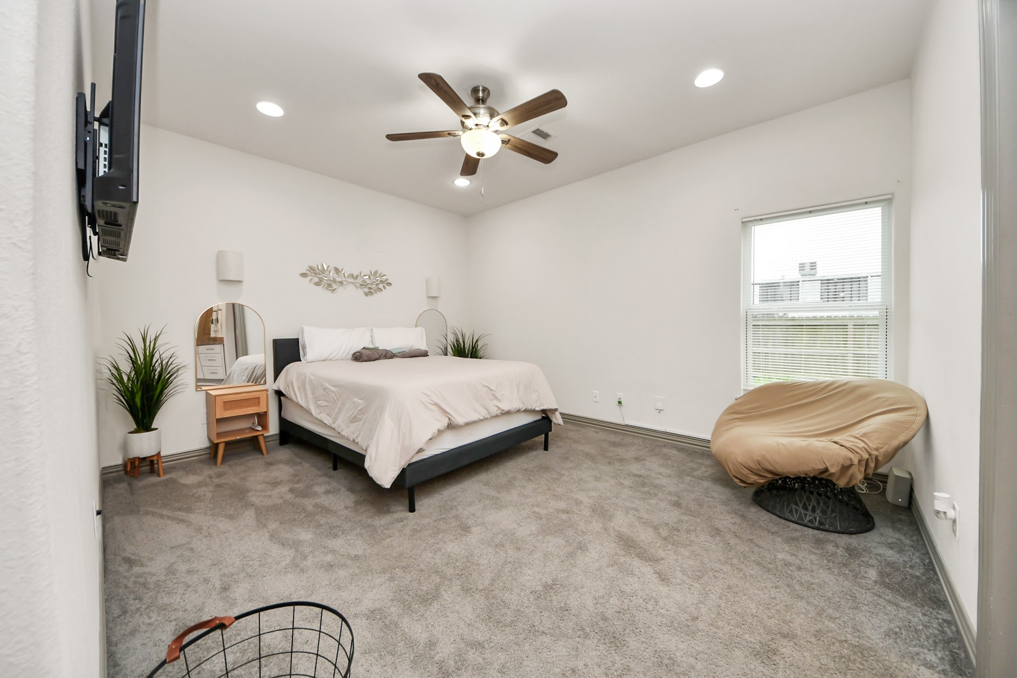 5334 Pershing Street Houston, TX 77033 - Photo 13 of 43 a bedroom with a bed and a chandelier