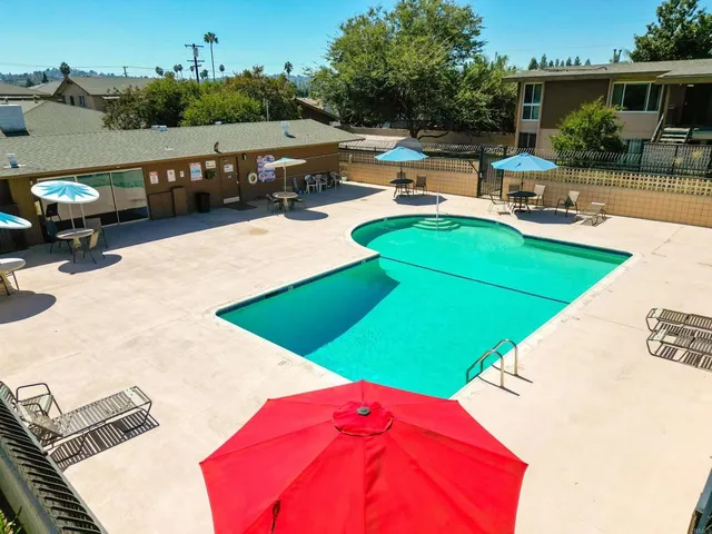 swimming pool view with a seating space