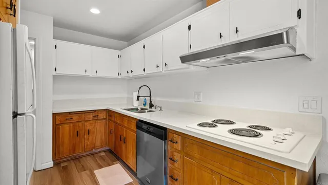 a kitchen with a sink a stove and cabinets