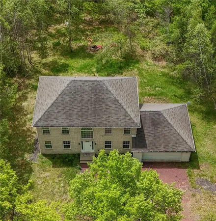 an aerial view of a house with yard and outdoor space