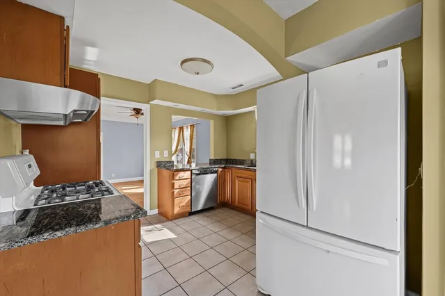a kitchen with a refrigerator and a stove