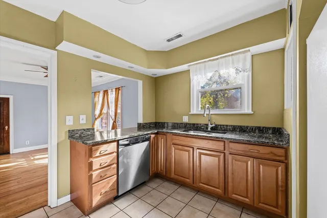 a kitchen with stainless steel appliances granite countertop a sink and cabinets