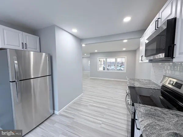 a kitchen with stainless steel appliances a refrigerator stove microwave and sink