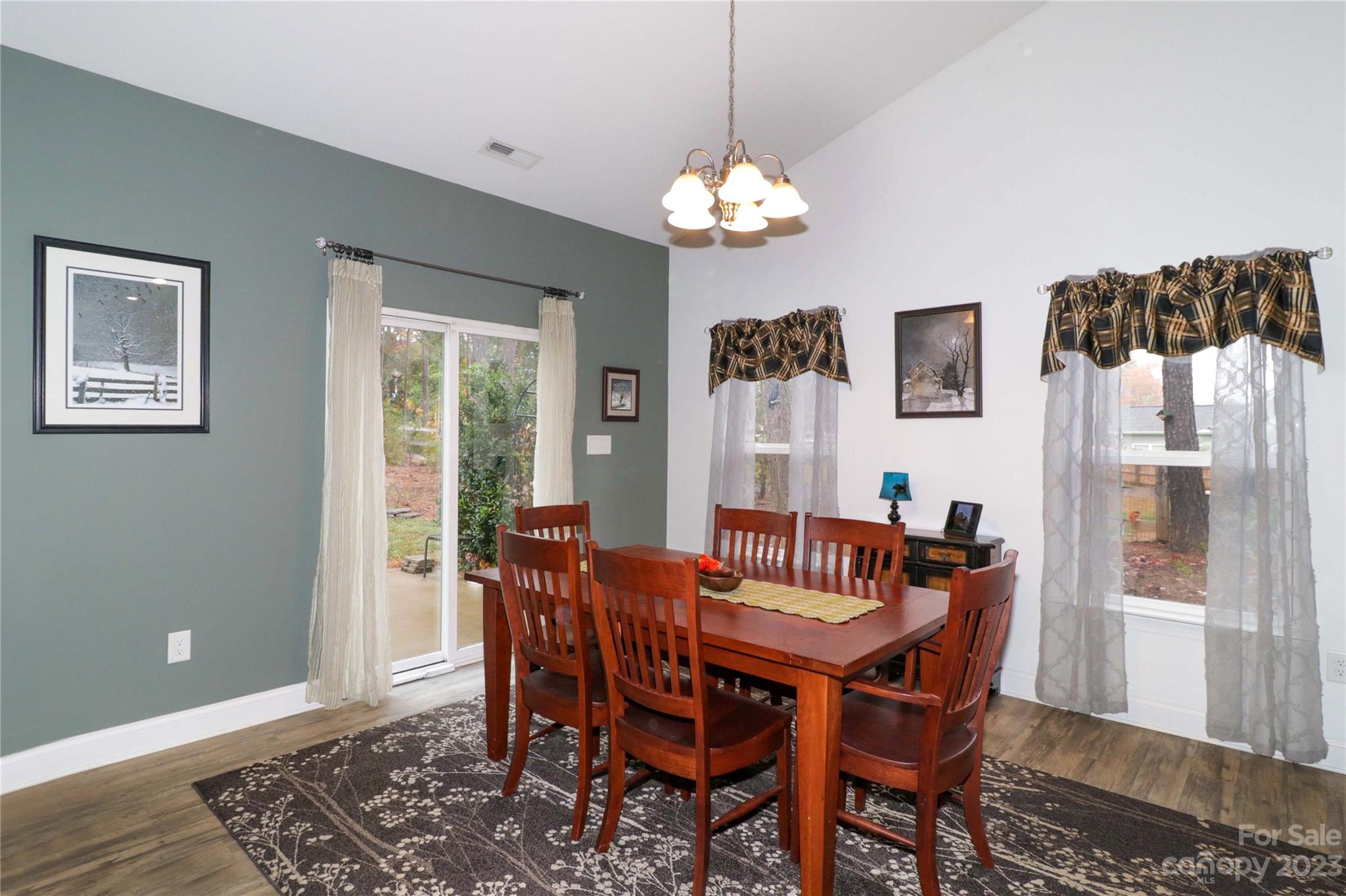117 Windstone Drive Troutman, NC 28166 - Photo 15 of 40 a view of a dining room with furniture a chandelier and wooden floor