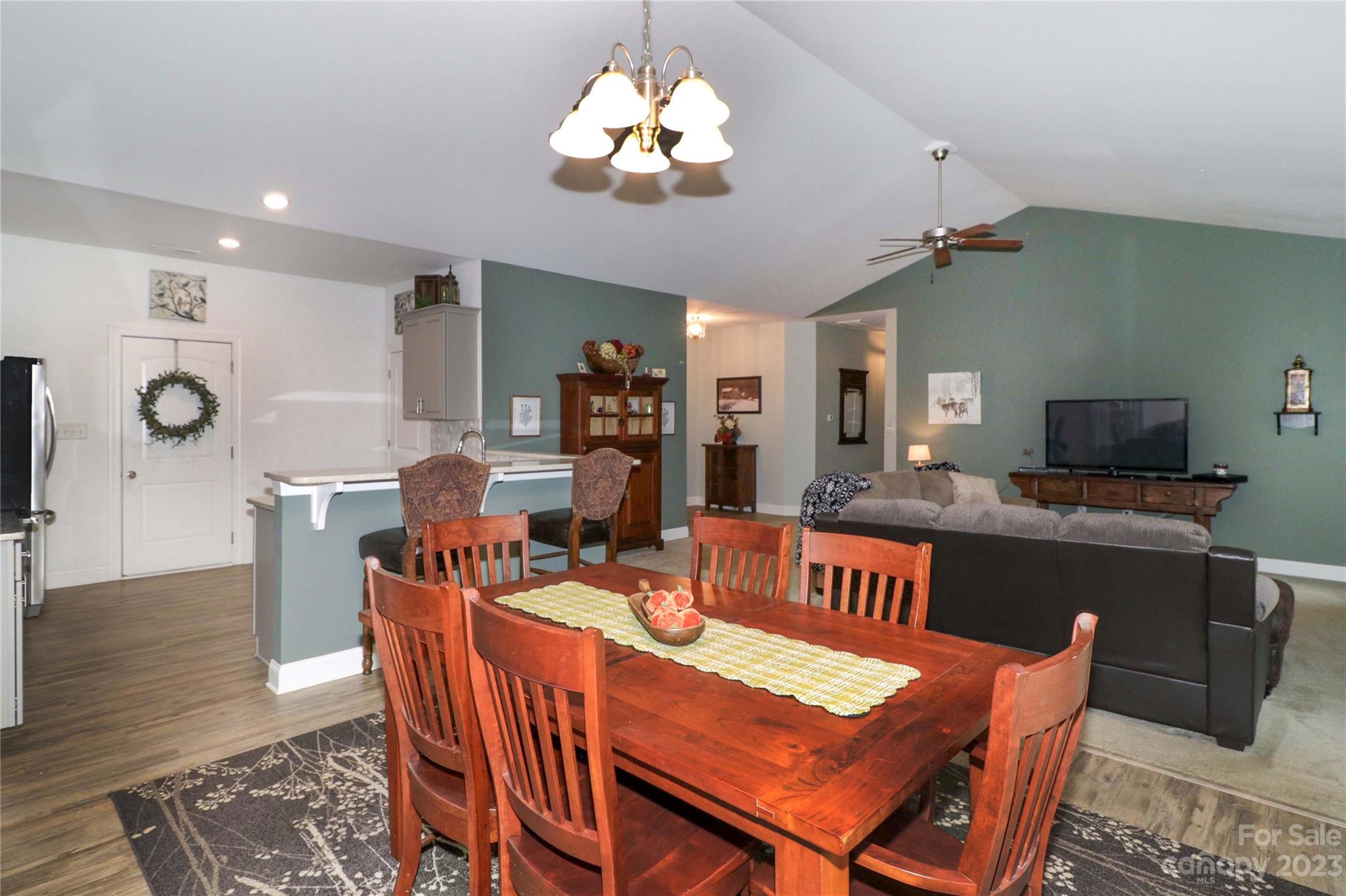 117 Windstone Drive Troutman, NC 28166 - Photo 16 of 40 a view of a dining room with furniture a chandelier and wooden floor