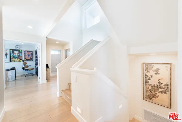 a view of staircase with furniture and a kitchen