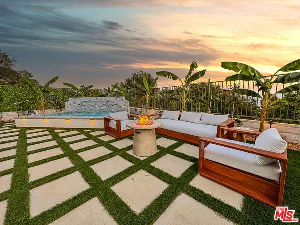 a outdoor space with patio couch and a potted plant