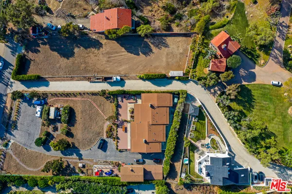 an aerial view of residential houses and car parked