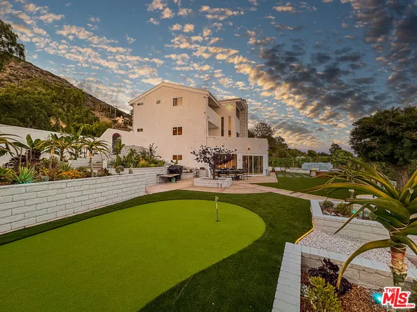 a view of swimming pool with outdoor seating and plants