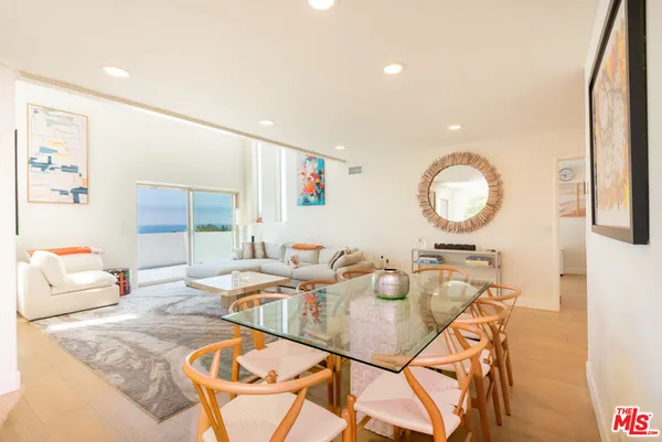 a living room with furniture and a mirror