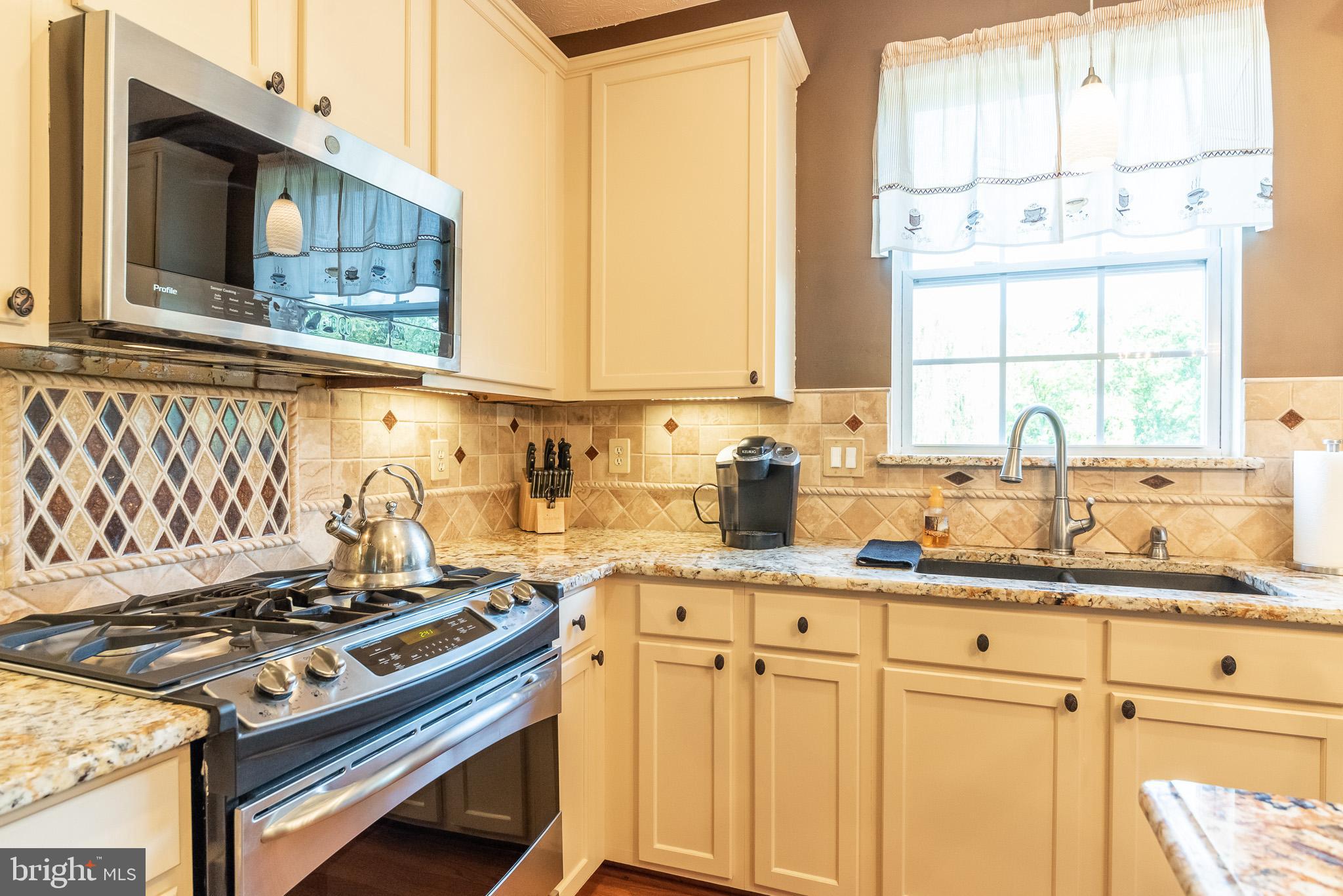 1907 Wagner Farm Road Bel Air, MD 21015 - Photo 13 of 67 a kitchen with stainless steel appliances granite countertop a sink stove and cabinets